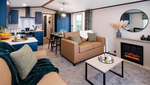 a living room with a couch and a fireplace at Seaton Estate in Arbroath