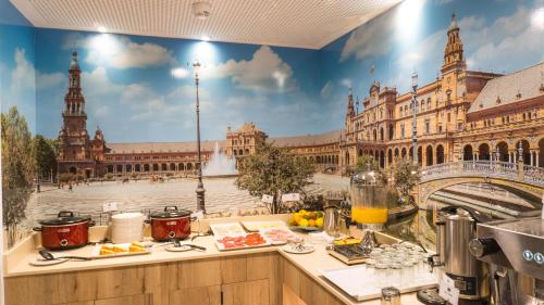 a kitchen with a mural of a large building at Hotel AV la Florida in Seville