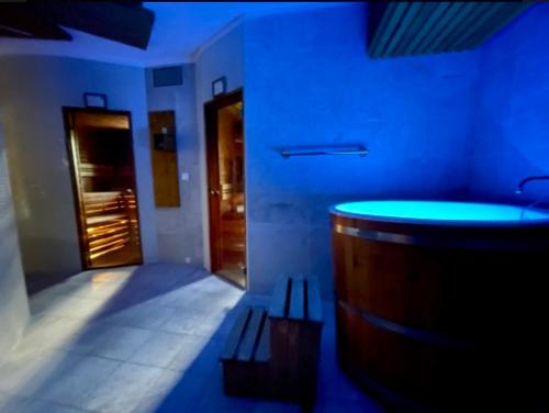 a blue room with a tub in a bathroom at Apartmán Vŕšky Terchová in Terchová