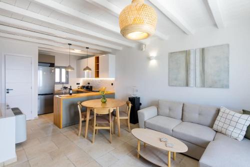 a living room with a couch and a table at Kea 360 VILLAS- Dionysos Den in Korissia
