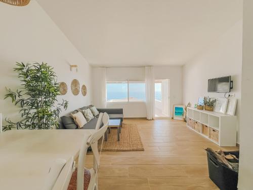 a living room with a couch and a table at Apartamentos Sol Naixent in L'Ametlla de Mar