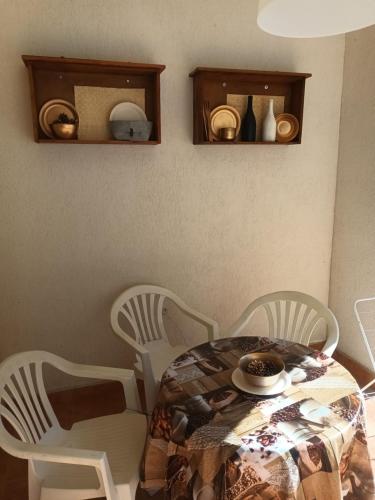 a dining room table with chairs and a table with a plate at STUDIO DELUXE IN MARINA CAPE 4 stars complex 33 7 in Aheloy