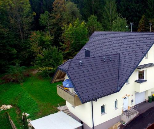 an overhead view of a house with a black roof at Forest House in Bled