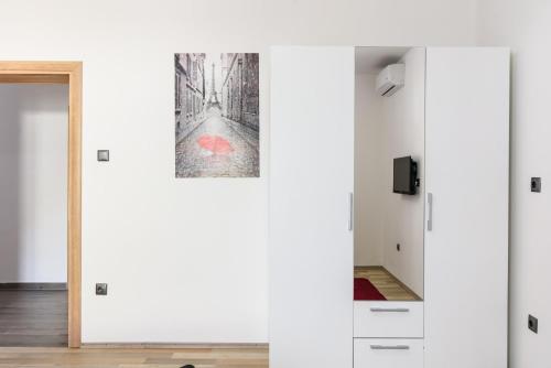 a room with white walls and a painting on the wall at Villa Mihaela with private pool, jacuzzi and free secure parking in Trogir