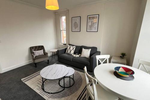 a living room with a couch and a table at Large apt, sleeps 4, in picturesque Wimborne town - The Westborough Nook in Wimborne Minster
