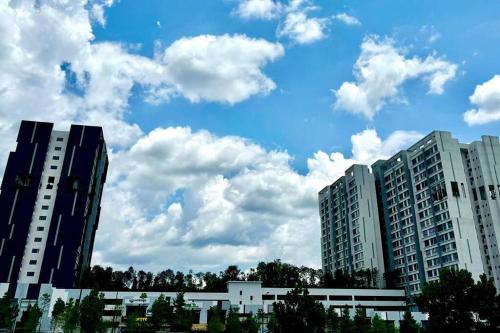 two tall buildings with clouds in the sky at GAIA RESIDENCE Gamuda Garden Rawang Skyline Luge in Rawang