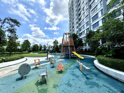 a playground with a slide and chairs in a building at 2R2B GAIA RESIDENCE Gamuda Garden Rawang SkylineLuge in Rawang