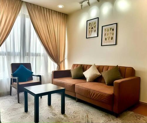 a living room with a couch and a table at GAIA RESIDENCE Gamuda Garden Rawang Skyline Luge in Rawang