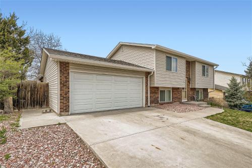 a house with a garage in front of it at Centrally located for adventures in Westminster