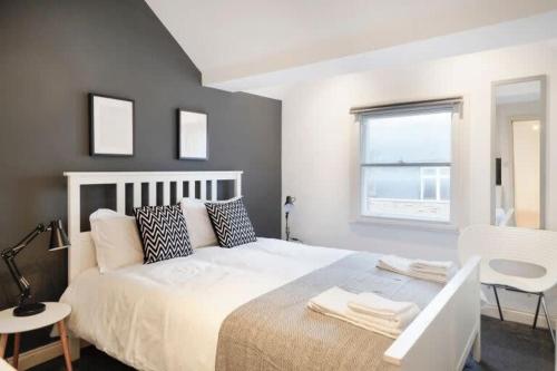a bedroom with a white bed and a window at New Soho Loft - Apt 3 by Indigo Flats in London