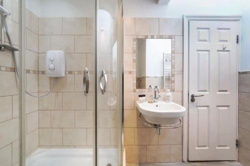 a bathroom with a shower and a sink at New Soho Loft - Apt 3 by Indigo Flats in London