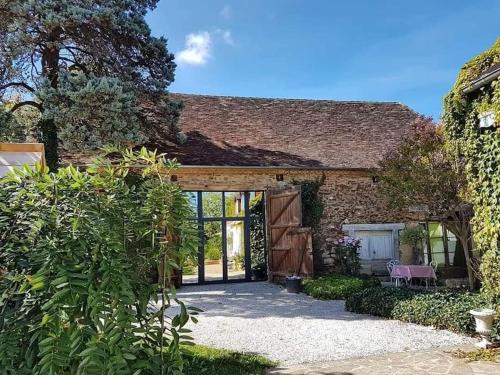 an external view of a house with a patio at La Grange in Sarlande