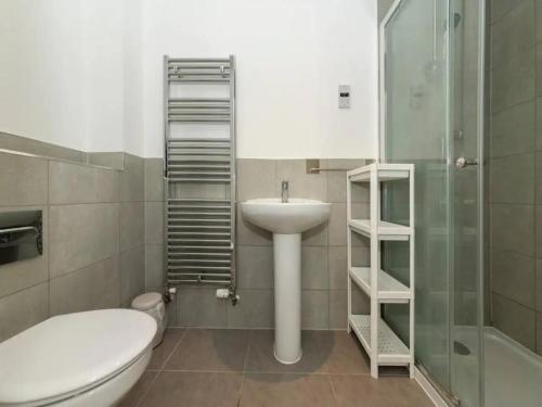 a bathroom with a sink and a toilet and a shower at Pass the Keys Semi-detached house with garden and free parking in Shinfield