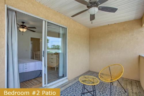 a room with two chairs and a ceiling fan at Estrella del Mar in Panama City Beach