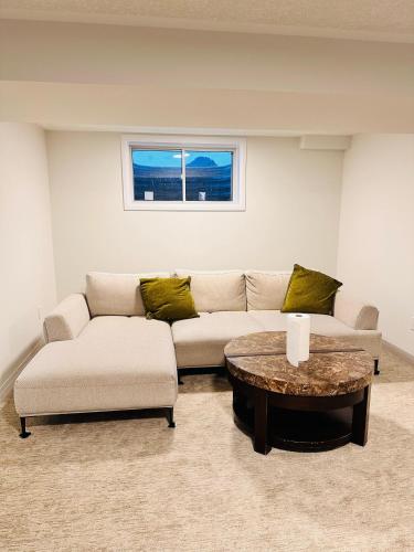 a living room with a couch and a coffee table at Private and spacious Basement in Kitchener