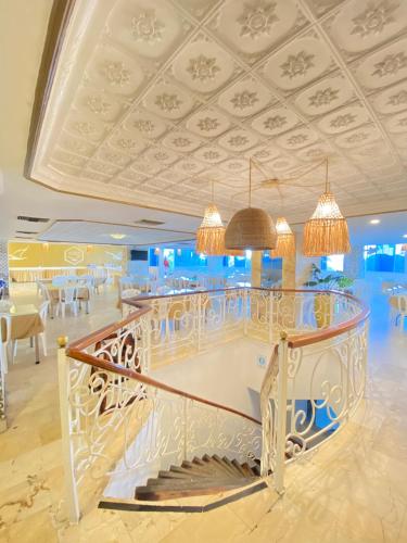a lobby of a hotel with a staircase and chandeliers at Hotel Cartagena Premium in Cartagena de Indias