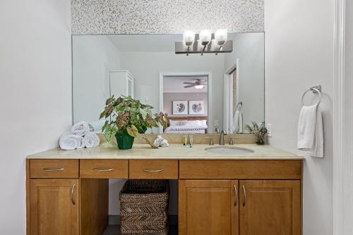 a bathroom with a sink and a large mirror at Relaxing Beach Apt in las Olas Blvd in Fort Lauderdale