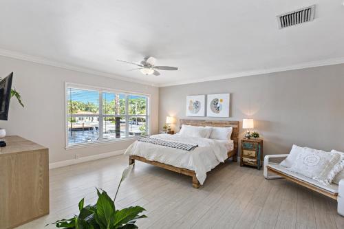 a white bedroom with a bed and a window at Relaxing Beach Apt in las Olas Blvd in Fort Lauderdale
