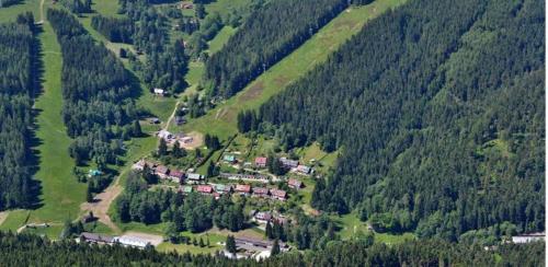 an aerial view of a house in the middle of a mountain at Apartment Herlikovice in Trutnov