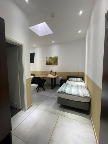 a bedroom with a bed and a desk in it at Stadtpension Heilbronn in Heilbronn