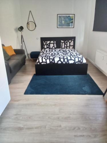 een slaapkamer met een bed en een blauw tapijt bij Appartement gare du midi in Brussel