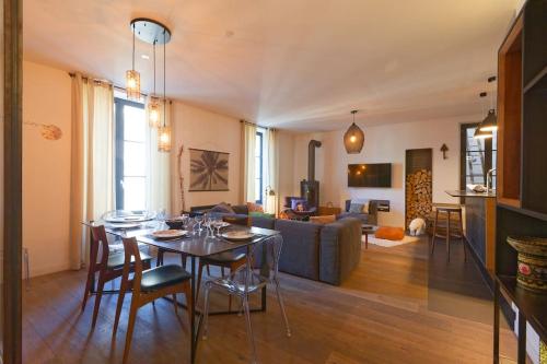 un salon avec une table et un canapé dans l'établissement L'Olympe - triplex avec spa et rooftop Classé 4*, à La Rochelle