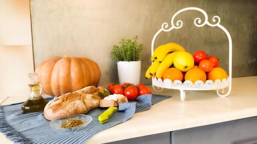 a table topped with a basket of fruit and vegetables at Casa Domenica in Zakynthos Town