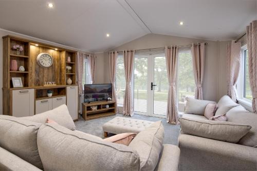 a living room with two couches and a tv at Seaton Estate in Arbroath
