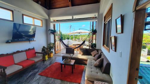 a living room with a couch and a tv at Alma de cedrela in Puerto Ayora
