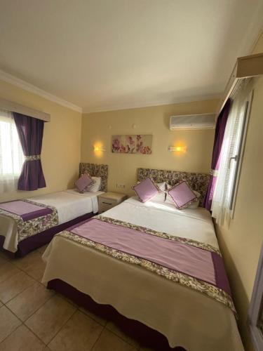 Una cama o camas en una habitación de Canna Garden Hotel - Adult Only