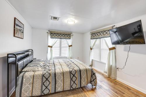 a bedroom with a bed and a flat screen tv at Charming El Dorado Retreat Near Main Street! in El Dorado