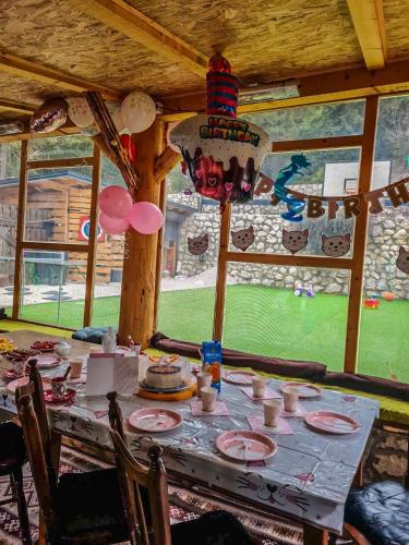 a table with a cake and balloons on it at Vila Bašić Vlašić Spa Apartman JELEN in Vlasic