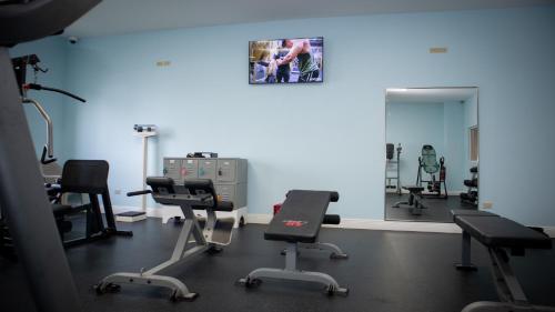 a gym with several chairs and a mirror at Princess Vegas Hotel & Casino in Corozal