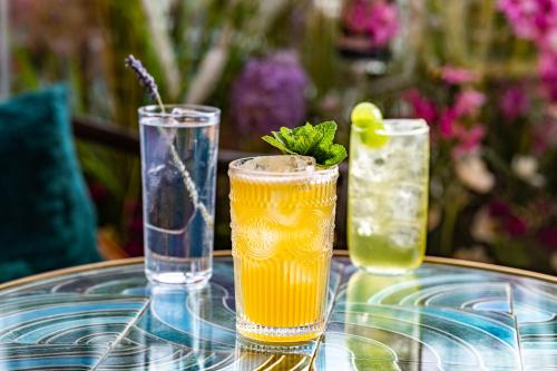 three drinks on a glass table on a table at Harbour Hotel & Spa Southampton in Southampton