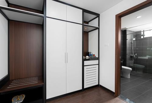 a bathroom with a walk in shower and a toilet at Hoang Yen Boutique Hotel in Dien Ban