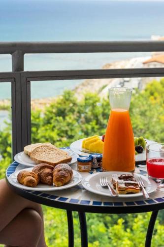 a tray of breakfast foods and orange juice on a balcony at Grand Hotel Santa Maria in Santa Maria di Castellabate