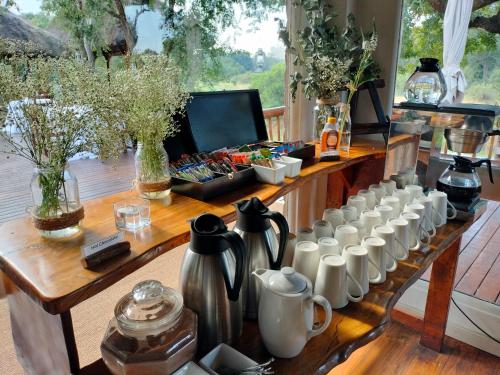 a table with a bunch of white cups on it at Karongwe - River Safari Lodge in Hoedspruit