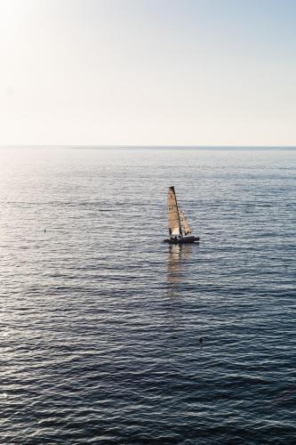 a small sail boat in the middle of the water at Grand Hotel Santa Maria in Santa Maria di Castellabate