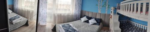 two pictures of a bedroom with a bed and a crib at Apartament W sam Raz in Słupsk