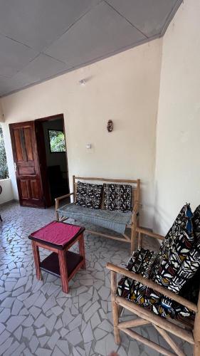 a room with couches and a table in a room at Lodge Jamarek in Kafountine