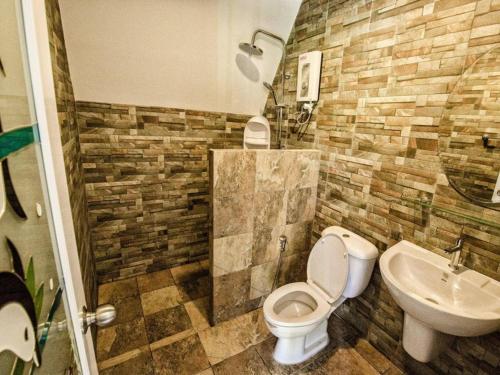 a bathroom with a toilet and a sink at Mountain View Resort and Phupha Srirung Resort in Phuket