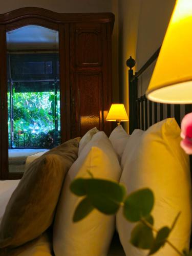 a bedroom with a bed with pillows and a window at BE Jardin Escondido By Coppola in Buenos Aires