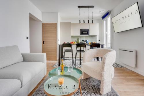 a living room with a couch and a table at KAZA BELLA - Maisons Alfort 7 - Large modern family flat in Maisons-Alfort