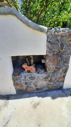a brick oven with a red item sitting on top of it at Alma de cedrela in Puerto Ayora