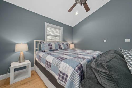 a bedroom with a bed and a ceiling fan at Sunset Cove Lakefront Luxury Lodge with Private Dock in Dandridge
