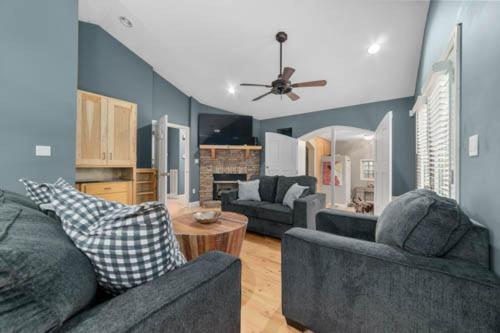 a living room with two couches and a table at Sunset Cove Lakefront Luxury Lodge with Private Dock in Dandridge