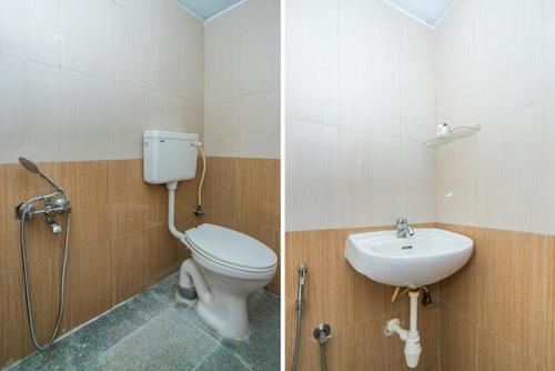 a bathroom with a toilet and a sink at Western Silicon Hotel in Bengaluru