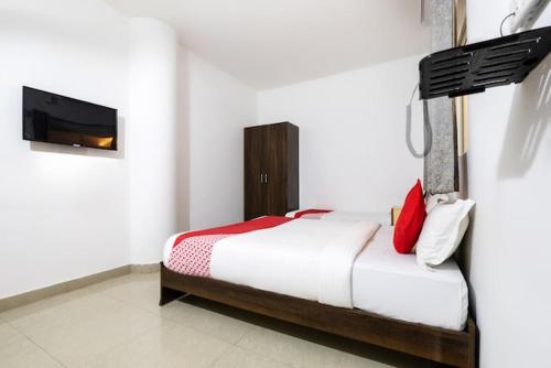 a bedroom with a bed and a television in it at Western Silicon Hotel in Bengaluru