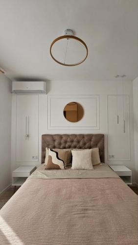 a bedroom with a large bed with white walls at Monte View Apartments in Ulcinj