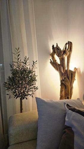 a bedroom with a bed and a tree stump lamp at Monte View Apartments in Ulcinj
